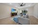 Comfortable living area showcasing a large sectional, neutral decor, and large windows for natural light at 15261 Mille Fiore Blvd, Port Charlotte, FL 33953