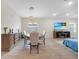 Open-concept living space featuring wood-look tile floors and a mounted television at 15261 Mille Fiore Blvd, Port Charlotte, FL 33953