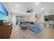Spacious living room with a large sectional sofa, decorative pillows, and a sliding glass door at 15261 Mille Fiore Blvd, Port Charlotte, FL 33953