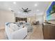Open living area with a view of the kitchen, dining space, and a comfortable sectional sofa at 15261 Mille Fiore Blvd, Port Charlotte, FL 33953