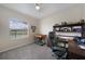 Office space with a desk, chair, shelving unit, and natural lighting at 15261 Mille Fiore Blvd, Port Charlotte, FL 33953