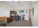 Office featuring a desk, shelving unit, and a TV, plus lots of natural light at 15261 Mille Fiore Blvd, Port Charlotte, FL 33953