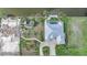 Aerial view showcasing the property's layout, including the pool, dock, and meticulous landscaping of the grounds at 15652 Havana Cir, Port Charlotte, FL 33981