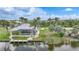 Tranquil home featuring screened lanai, lush yard, boat dock, and waterfront views at 15652 Havana Cir, Port Charlotte, FL 33981