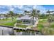 Aerial view of a waterfront property featuring a screened pool, private dock, and lush landscaping at 15652 Havana Cir, Port Charlotte, FL 33981