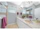 Bathroom featuring a double vanity with stone countertops and a walk-in shower at 15652 Havana Cir, Port Charlotte, FL 33981