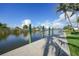 Concrete dock along a canal on a sunny day with a clear blue sky at 15652 Havana Cir, Port Charlotte, FL 33981