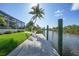 Dock overlooking the water with canal access and lush landscaping at 15652 Havana Cir, Port Charlotte, FL 33981