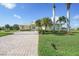 Inviting single-story home with a paved driveway, manicured lawn, and lush landscaping, radiating warmth and curb appeal at 15652 Havana Cir, Port Charlotte, FL 33981