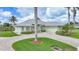 Well-maintained house with a circular driveway, lush lawn, and lovely landscaping at 15652 Havana Cir, Port Charlotte, FL 33981