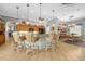 Spacious kitchen with bar seating, wood cabinets, and view of the dining area at 15652 Havana Cir, Port Charlotte, FL 33981