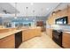 Well-lit kitchen with wood cabinets, granite counters and modern appliances at 15652 Havana Cir, Port Charlotte, FL 33981