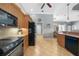 Traditional kitchen design with light wood cabinets, tile flooring, and modern black appliances at 15652 Havana Cir, Port Charlotte, FL 33981