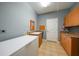 Functional laundry room with sink, cabinets, and neutral tile flooring at 15652 Havana Cir, Port Charlotte, FL 33981