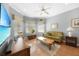 Comfortable living room with wood floors, ample seating, and a large screen television at 15652 Havana Cir, Port Charlotte, FL 33981