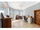 Home office with multiple desks, natural light, and tile flooring at 15652 Havana Cir, Port Charlotte, FL 33981