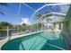 Screened pool and jacuzzi overlook the canal with boat dock at 15652 Havana Cir, Port Charlotte, FL 33981