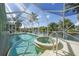 Sparkling pool and spa under a screened enclosure, with a waterfront view at 15652 Havana Cir, Port Charlotte, FL 33981