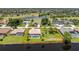 An aerial view showcases a waterfront home with screened-in pool, palms, and proximity to a golf course and community lake at 167 & 169 Marker Rd, Rotonda West, FL 33947