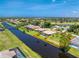 Beautiful aerial view of a waterfront home featuring a screened pool, lush landscaping, and a private dock at 167 & 169 Marker Rd, Rotonda West, FL 33947