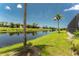 Green backyard with a serene canal, trees, and blue sky showcasing the property's natural beauty and location at 167 & 169 Marker Rd, Rotonda West, FL 33947