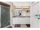 Bright bathroom with double sink, shower and large mirrors at 167 & 169 Marker Rd, Rotonda West, FL 33947