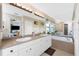 Bathroom with double sink, bathtub and large mirrors at 167 & 169 Marker Rd, Rotonda West, FL 33947