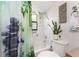 Bathroom with shower and tub combination, toilet, and garden themed decor and shower curtain at 167 & 169 Marker Rd, Rotonda West, FL 33947