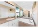 Bathroom with bathtub and large mirrors at 167 & 169 Marker Rd, Rotonda West, FL 33947