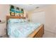 Bedroom with a queen bed, closet, ceiling fan, and beach themed wall hanging at 167 & 169 Marker Rd, Rotonda West, FL 33947
