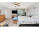 Bright bedroom with tray ceiling, ceiling fan, and sliding glass doors to the lanai at 167 & 169 Marker Rd, Rotonda West, FL 33947