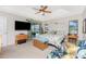 Bright bedroom with tray ceiling, ceiling fan, and sliding glass doors to the pool at 167 & 169 Marker Rd, Rotonda West, FL 33947