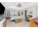 Spacious bedroom with tray ceiling, ceiling fan, ensuite bathroom, and tropical decor at 167 & 169 Marker Rd, Rotonda West, FL 33947
