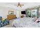 Spacious bedroom with tray ceiling, ceiling fan, stylish furniture, and sliding glass doors at 167 & 169 Marker Rd, Rotonda West, FL 33947