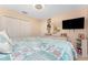 Bedroom with a queen bed, closet, dresser, mounted television and coastal themed decor at 167 & 169 Marker Rd, Rotonda West, FL 33947