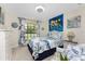 Bedroom with a bed, large window, a turtle tapestry, and coordinating coastal decor at 167 & 169 Marker Rd, Rotonda West, FL 33947