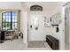 Bright foyer with large front door window, front hall bench and front hall decor at 167 & 169 Marker Rd, Rotonda West, FL 33947