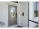 View of the front door and covered entryway with a leaded glass window at 167 & 169 Marker Rd, Rotonda West, FL 33947