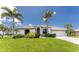 Beautiful single-story home with well-manicured lawn, mature palms, and a welcoming facade at 167 & 169 Marker Rd, Rotonda West, FL 33947