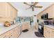 Spacious kitchen with wood cabinetry, stainless steel appliances and open view to other living areas at 167 & 169 Marker Rd, Rotonda West, FL 33947