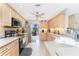 Bright kitchen with stainless appliances, tile floors and countertops, and plenty of cabinet space at 167 & 169 Marker Rd, Rotonda West, FL 33947