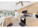 Kitchen with light wood cabinets, stainless steel appliances, and tile flooring at 167 & 169 Marker Rd, Rotonda West, FL 33947