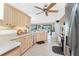 Kitchen featuring light wood cabinetry, stainless steel appliances, and views into the living area at 167 & 169 Marker Rd, Rotonda West, FL 33947
