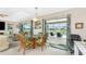 Open living space featuring a dining table, glass sliding doors overlooking the pool at 167 & 169 Marker Rd, Rotonda West, FL 33947