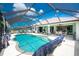 Relaxing screened-in pool and patio area features clear water, outdoor seating, and a view of the backyard at 167 & 169 Marker Rd, Rotonda West, FL 33947