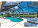 Relaxing screened-in pool and patio area features clear water, lounge chairs, and a view of the backyard at 167 & 169 Marker Rd, Rotonda West, FL 33947