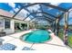 Beautiful screened-in pool and patio with outdoor seating, overlooking the backyard and canal view at 167 & 169 Marker Rd, Rotonda West, FL 33947