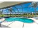 Inviting screened-in pool and patio area with clear blue water, lounge chairs, and peaceful backyard canal views at 167 & 169 Marker Rd, Rotonda West, FL 33947