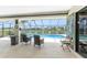 View of screened lanai featuring covered seating area with pool view at 167 & 169 Marker Rd, Rotonda West, FL 33947