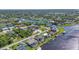 Aerial view of waterfront community with canals, docks, and lush landscaping at 18566 Arapahoe Cir, Port Charlotte, FL 33948